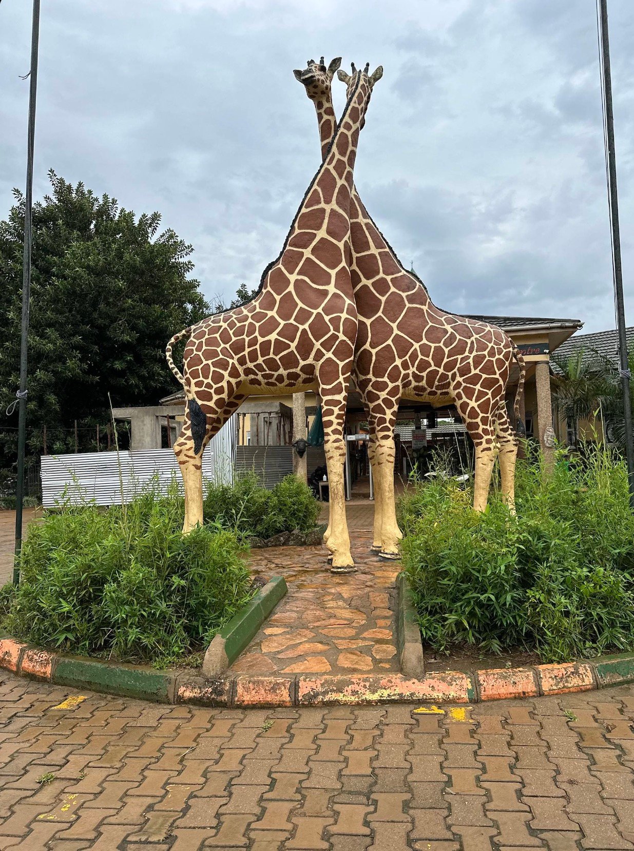 Twin-giraffe sculpture at the Uganda Wildlife Education Centre entrance, Entebbe, Hello East Africa